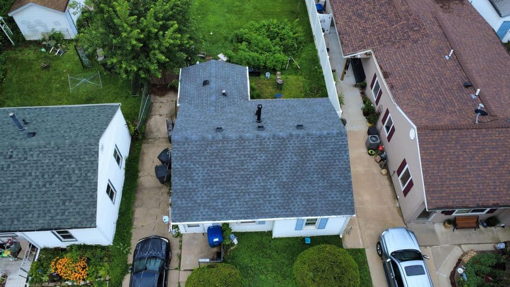 Aerial view of a residential neighborhood with houses and green lawns.